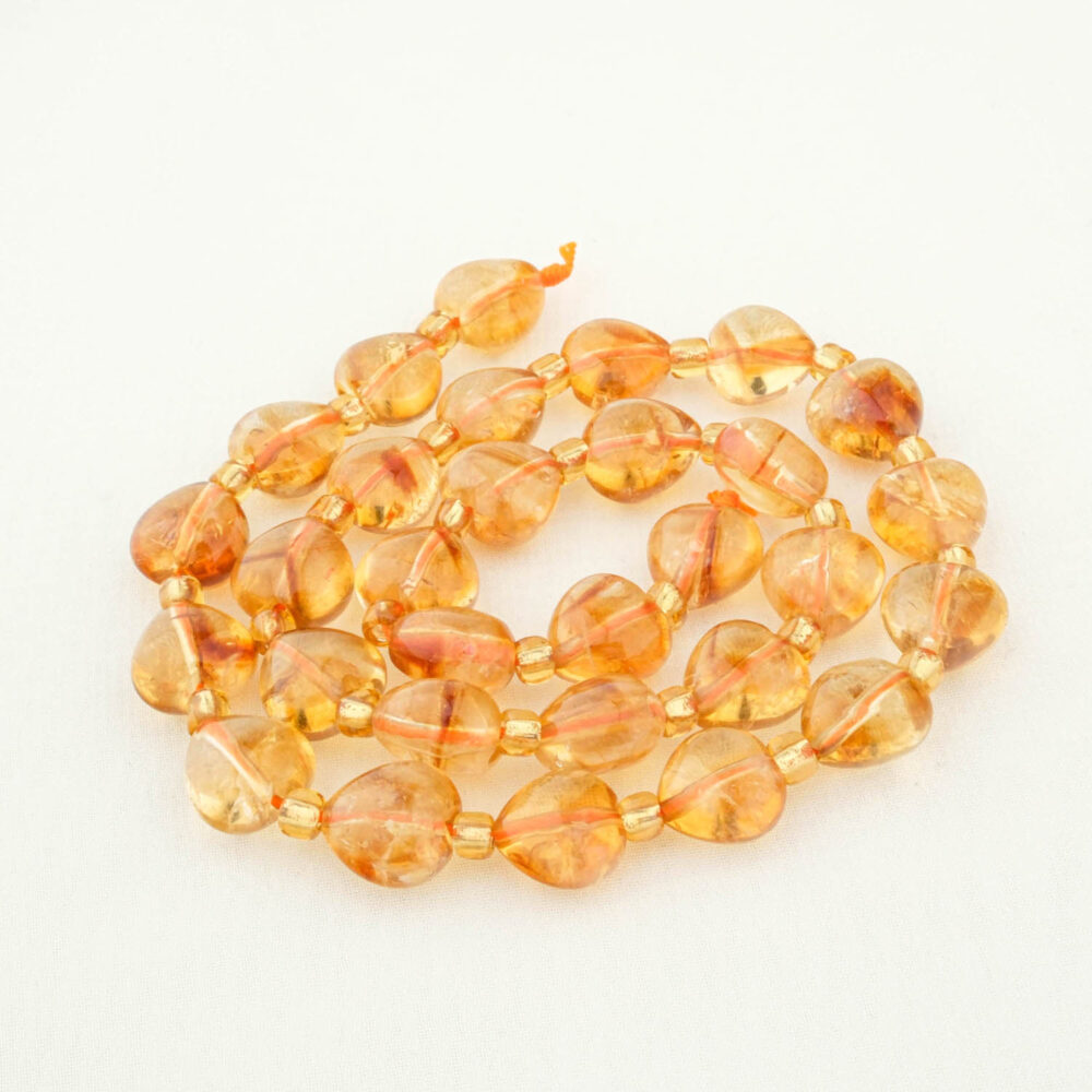 Side view of high-quality Citrine bead (10mm), ideal for jewelry making and solar plexus chakra alignment.