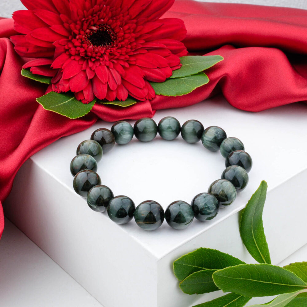 Premium 5A+ Cat's Eye stone bracelet (10-11mm) with grey-green chatoyant beads, displayed on a white box.