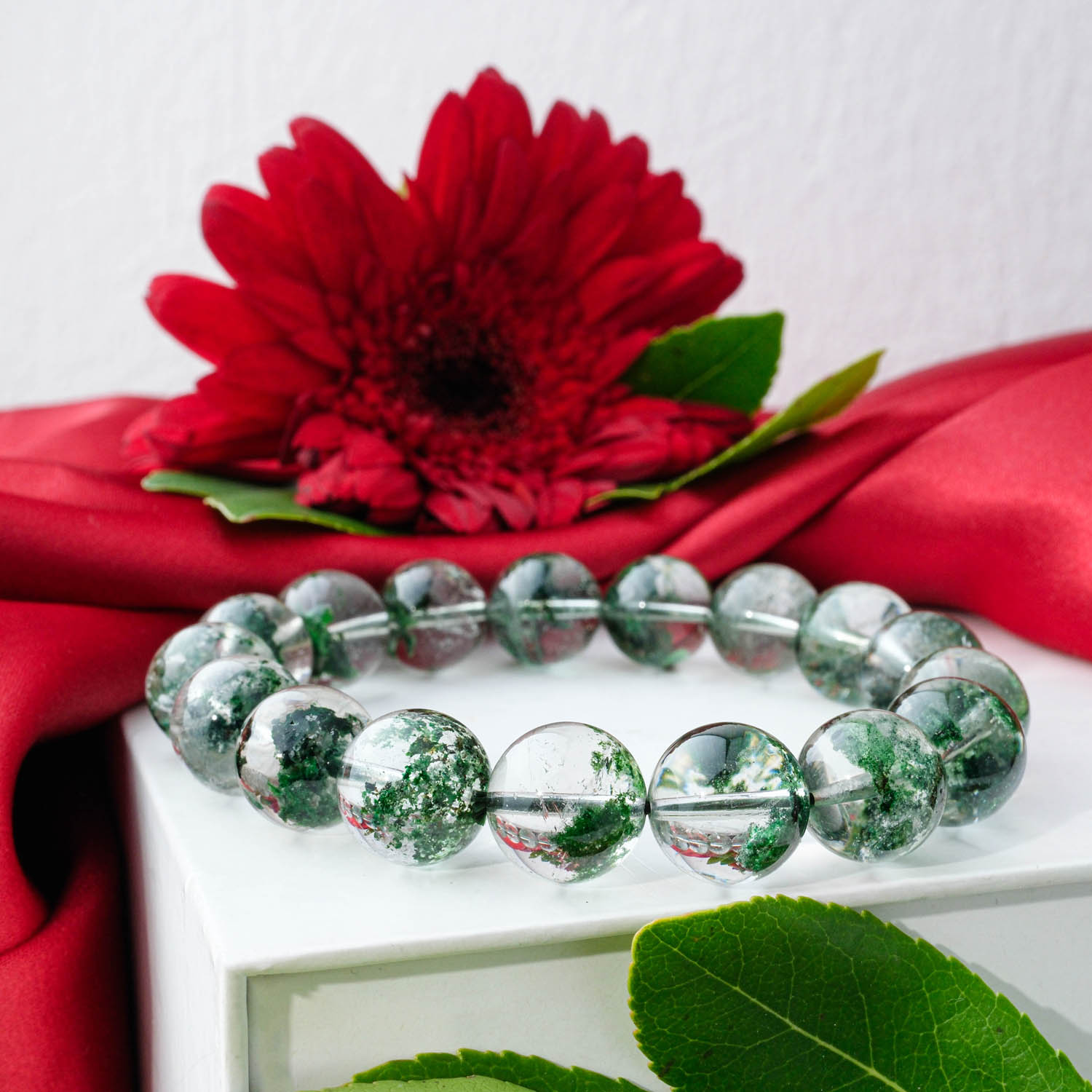 Premium 5A+ Green Garden Quartz (Lodolite) bracelet 13-14mm with large clear beads showing green inclusions, on white box.