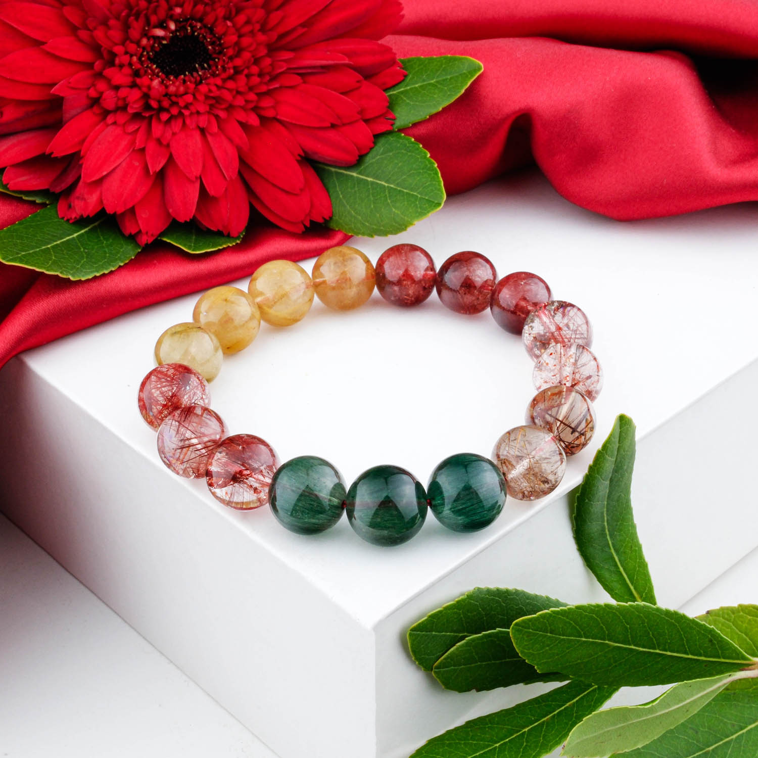 5a-multicolor-rutilated-quartz-bracelet-13mm A 5A+ quality 13mm multicolor rutilated quartz beaded bracelet on a white box.