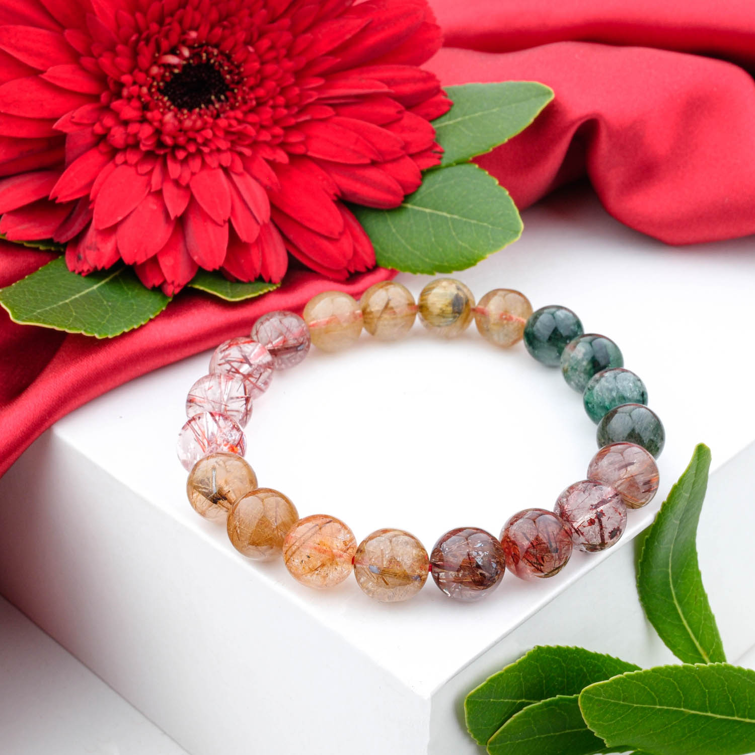 5a-multicolor-rutilated-quartz-bracelet-9mm A 5A+ quality 9mm multicolor rutilated quartz beaded bracelet on a white box.