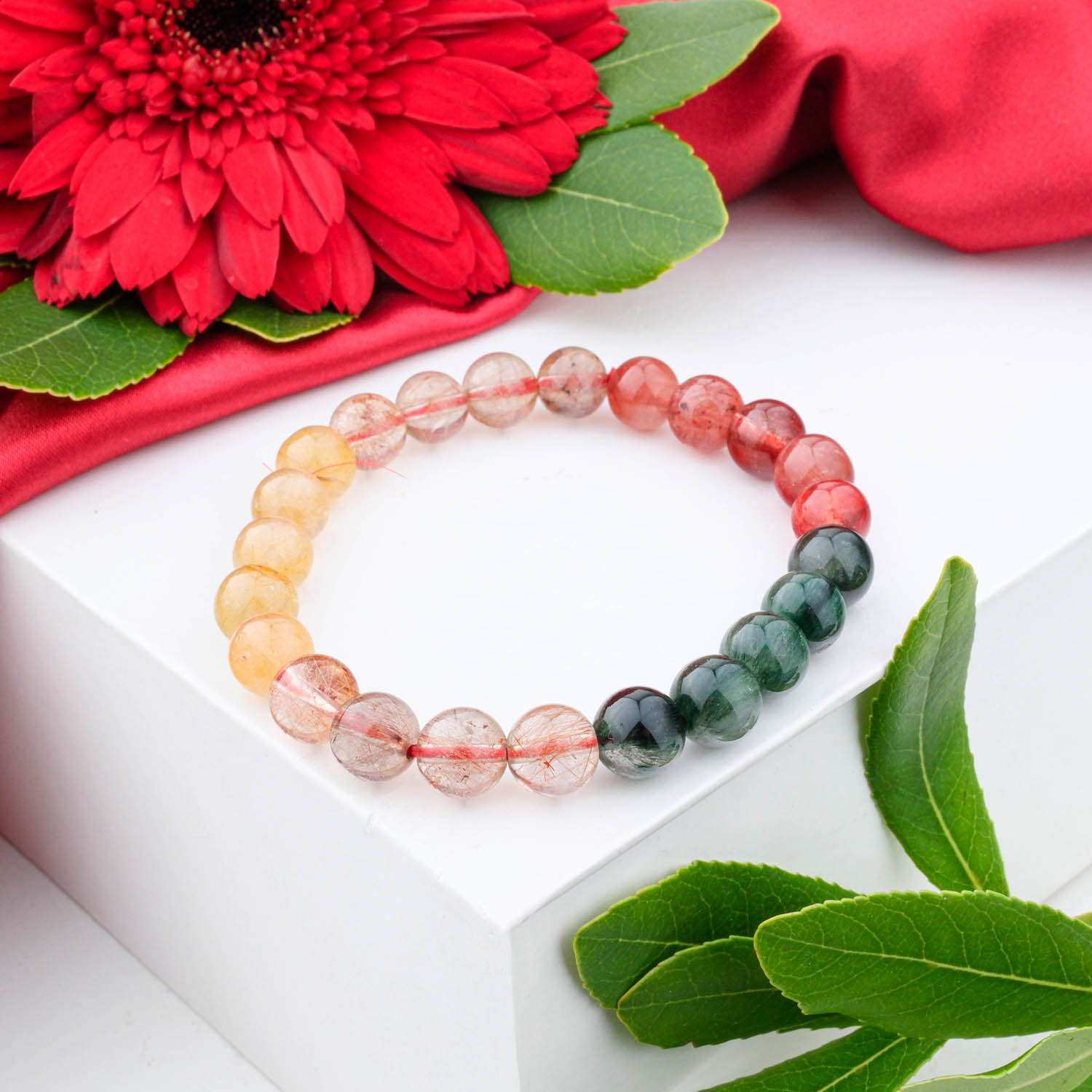 5a-multicolor-rutilated-quartz-bracelet-9mm A 5A+ quality 9mm multicolor rutilated quartz beaded bracelet on a white box.