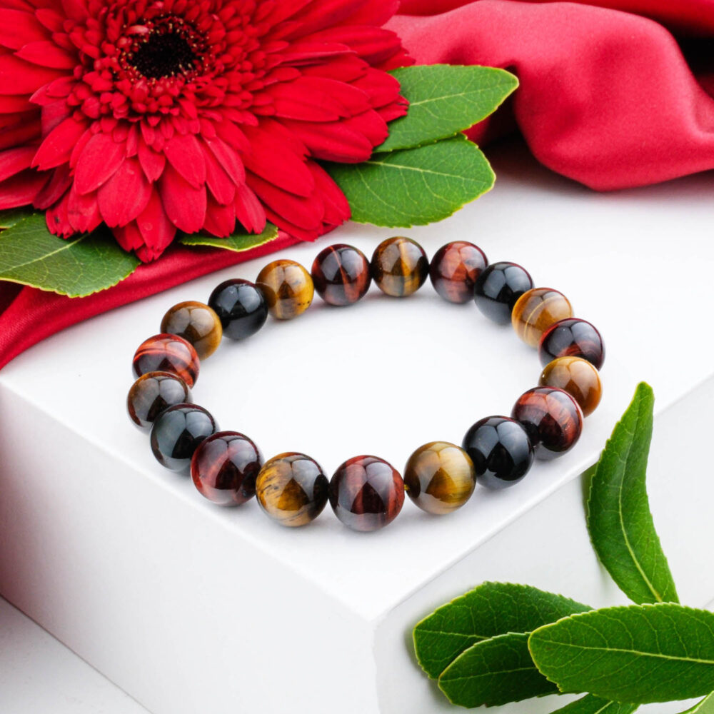 Premium 5A+ Multi-Color Tiger's Eye bracelet (10-11mm) with mixed golden and red chatoyant beads, on white box.