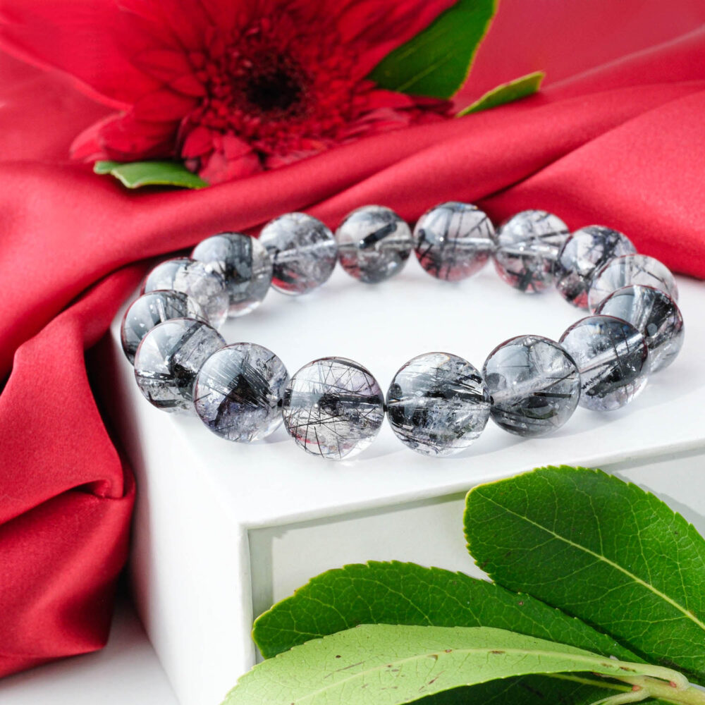 7A+ Grade Dark Black Rutilated Quartz bracelet (12-13mm) with clear beads and dense, thick black tourmaline needles.