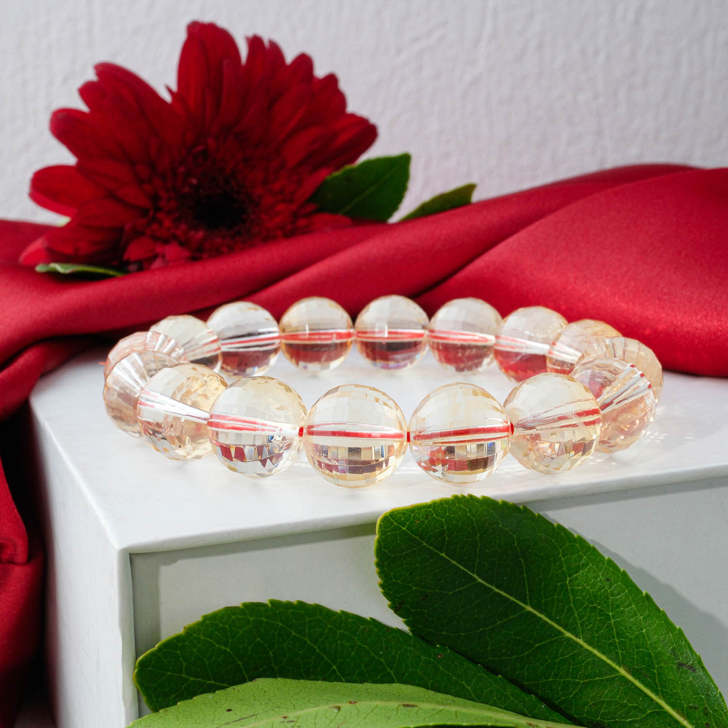 Premium 7A+ Ultra Clear Citrine bracelet (12-13mm) with large, faceted, light yellow beads sparkling on display.