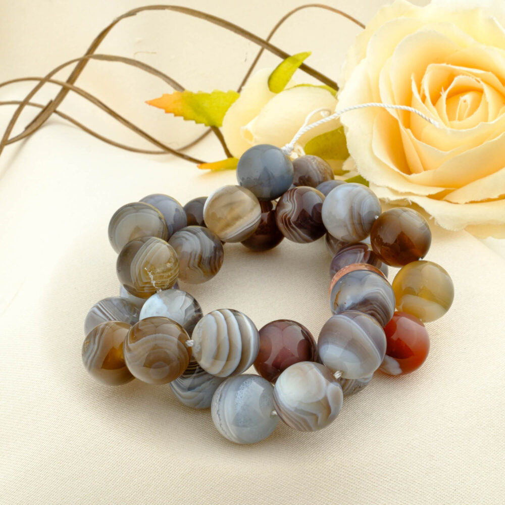 A double-wrapped strand of 12mm natural Botswana agate beads with fine grey, brown, and white bands.
