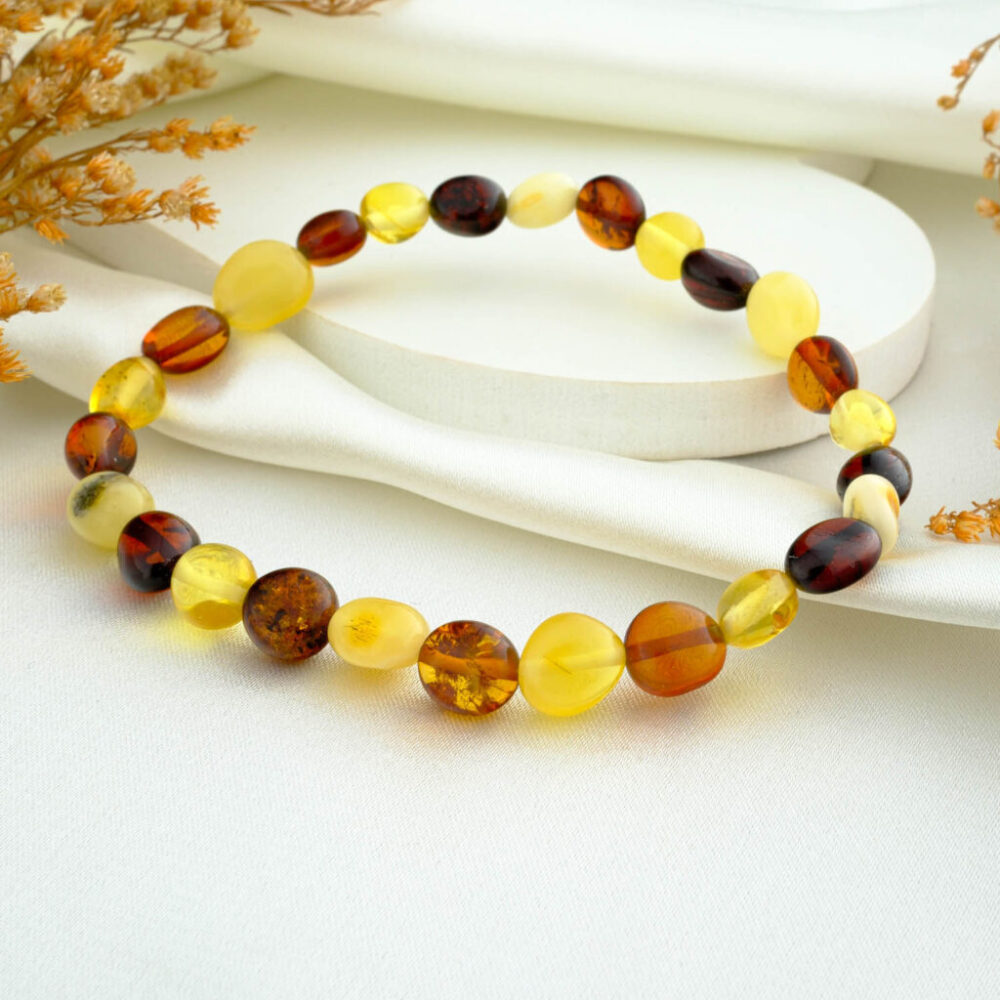 Certified amber amorphous mix bracelet for adults in lemon, honey and cognac tones on neutral fabric