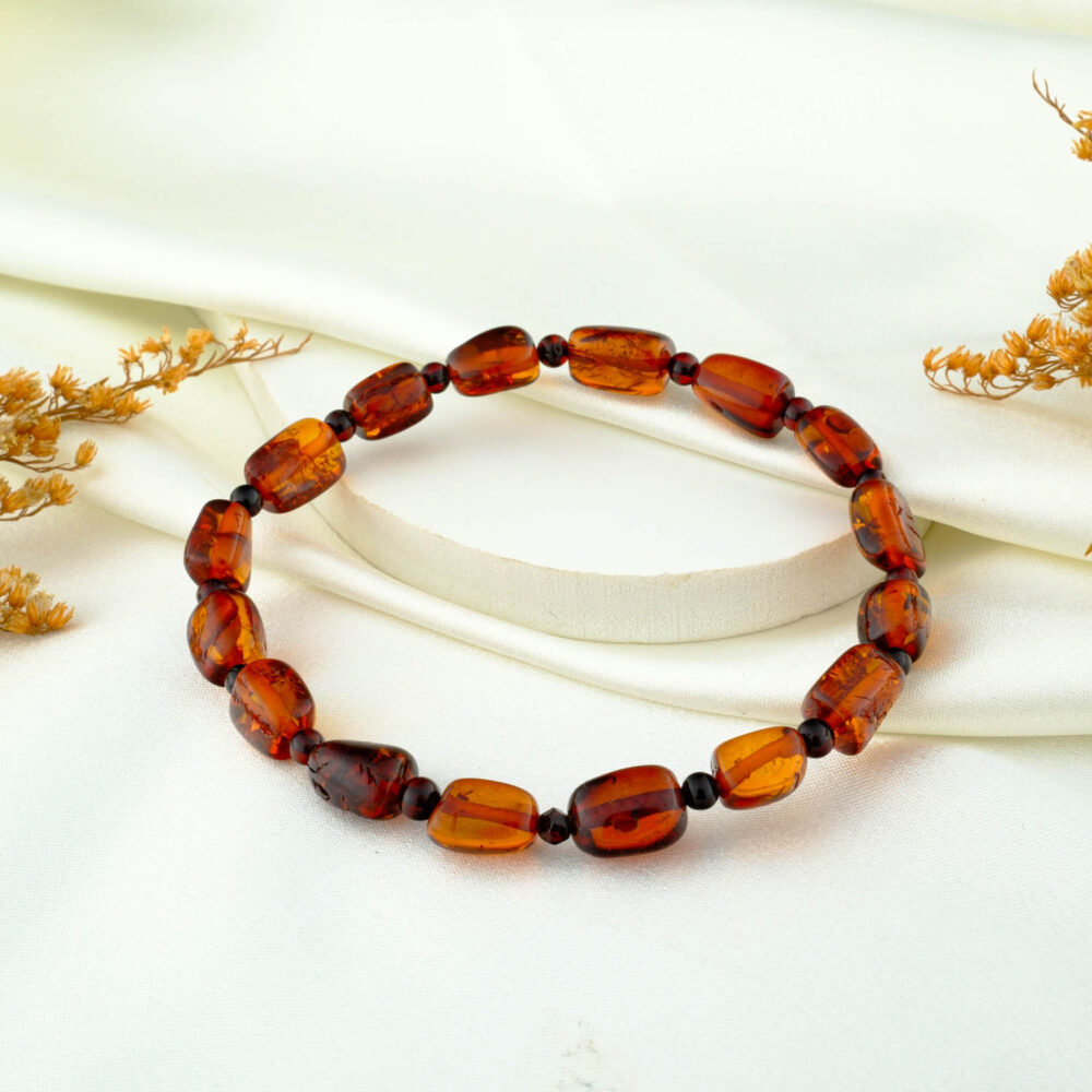 Certified amber bracelet with irregular freeform beads on neutral fabric