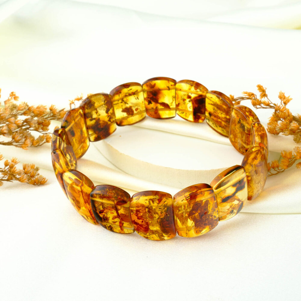 Certified amber “Rolex” panel bracelet on neutral fabric
