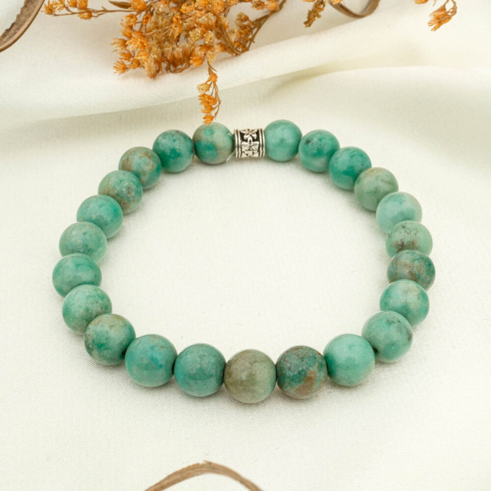 Chrysocolla 8 mm bead bracelet with decorative spacer on light fabric