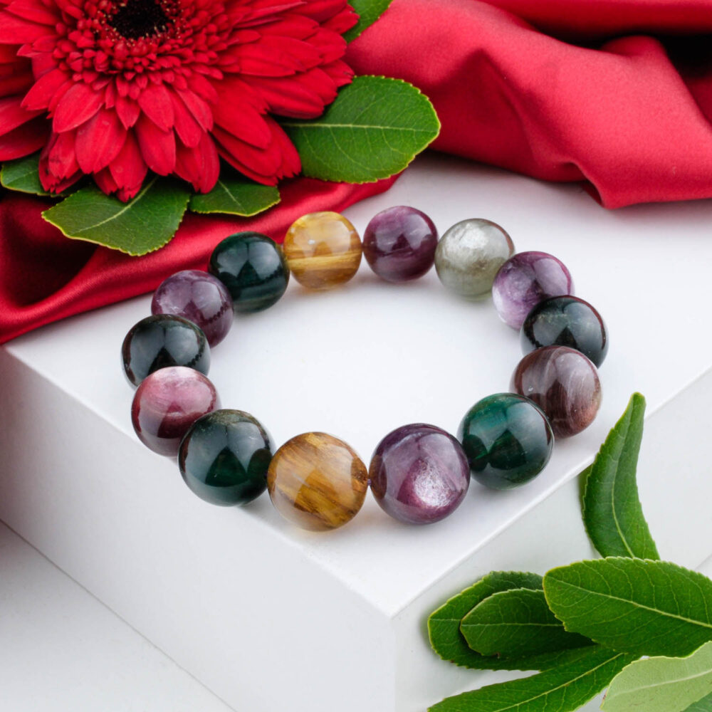 Premium 15-16mm bracelet with mixed Lepidolite and golden Tiger's Eye beads, on a white box with a red flower.