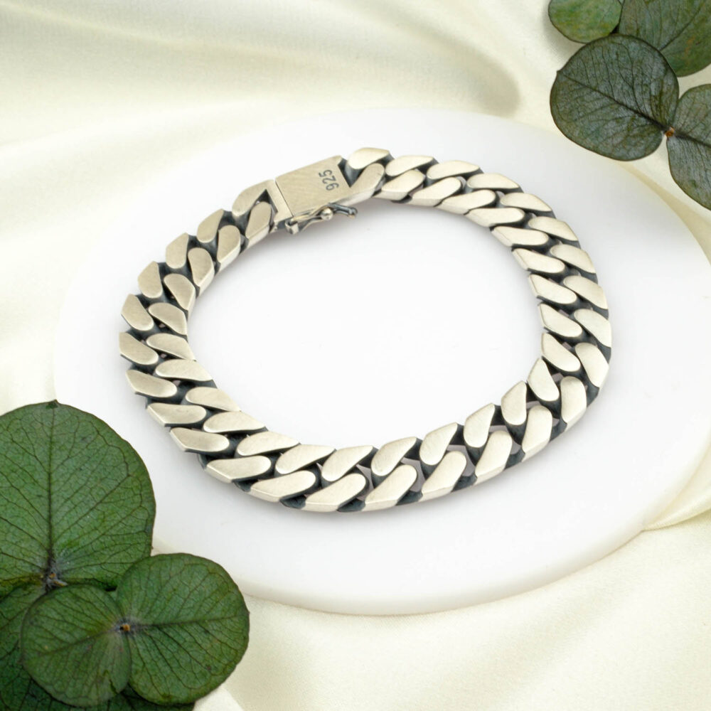 Matte square-link 925 sterling silver bracelet with box clasp on neutral backdrop