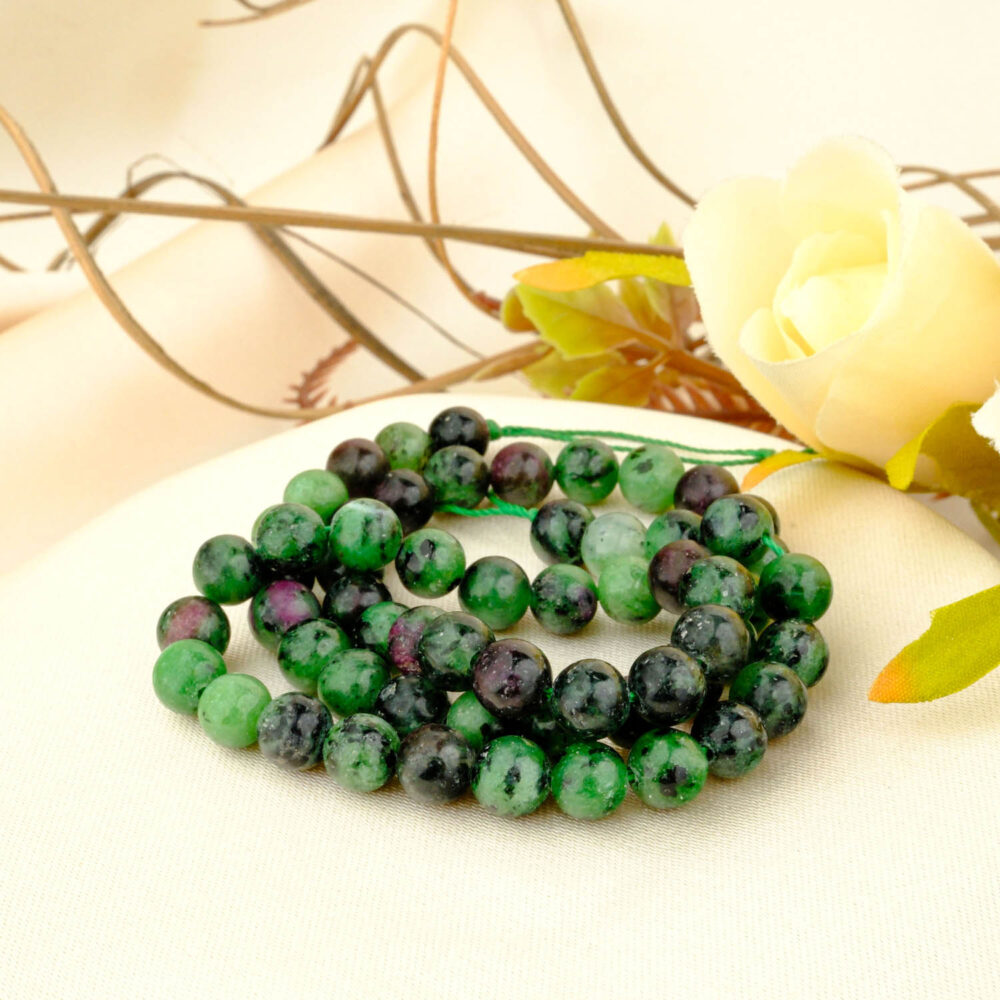A natural 10mm anyolite (ruby in zoisite) bead strand showing green and red stones, on a white background.