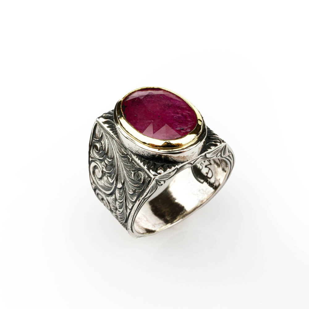 Side view of the 6.5ct ruby men's ring showing the intricate artisan engraving on the sterling silver band.