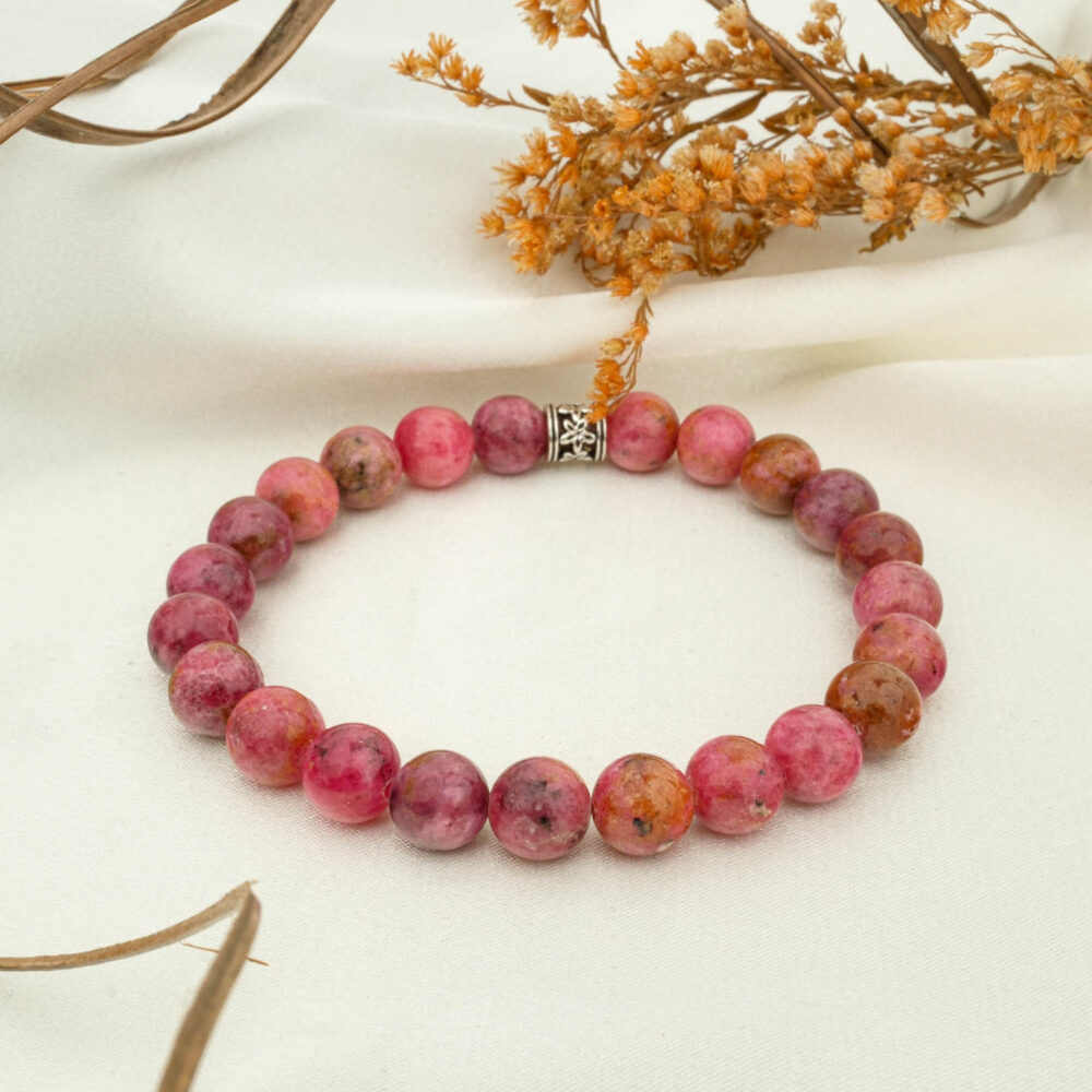 Pink rhodonite 8mm natural stone beaded bracelet on neutral fabric