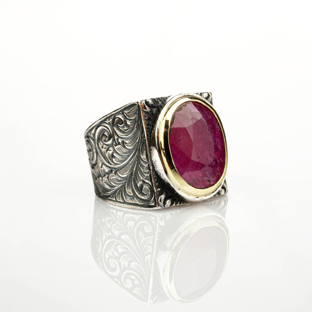 A natural 6.5ct red ruby ring for men, set in an ornate, handcrafted sterling silver mounting with a gold-tone bezel.