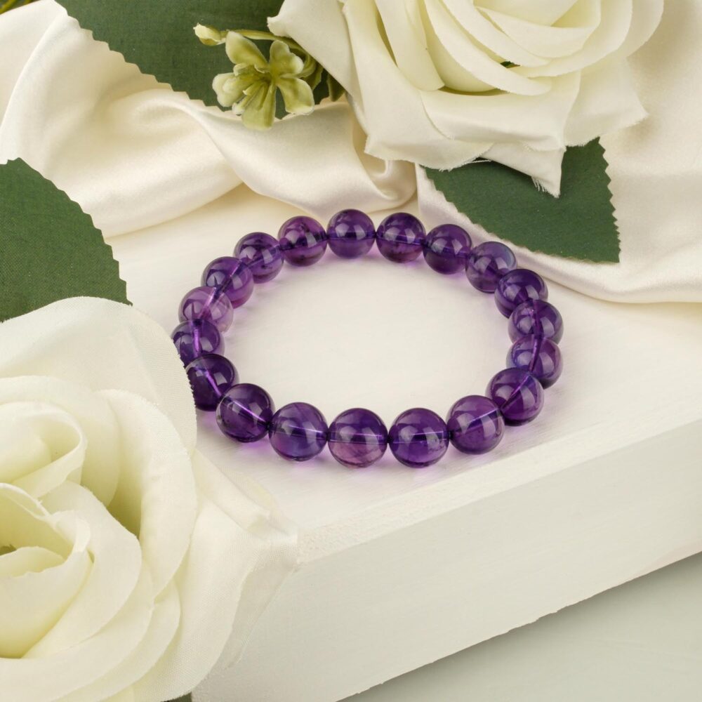 10A+ VIP quality amethyst bracelet with 10-11mm deep purple beads on white surface