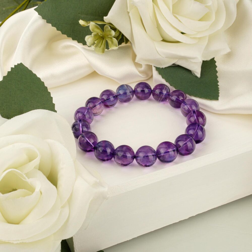 10A+ VIP quality amethyst bracelet with 11-12mm deep purple beads on white surface