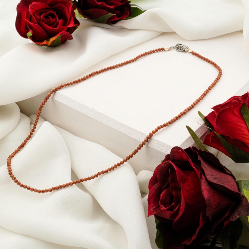 Delicate 2mm brown goldstone faceted bead necklace on white display