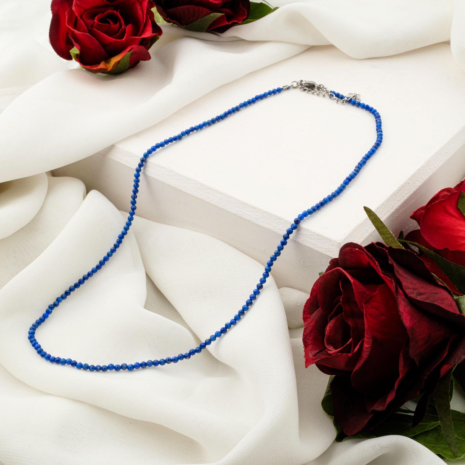 2mm-lapis-lazuli-faceted-necklace-royal-blue Delicate 2mm Lapis Lazuli faceted bead necklace on white display