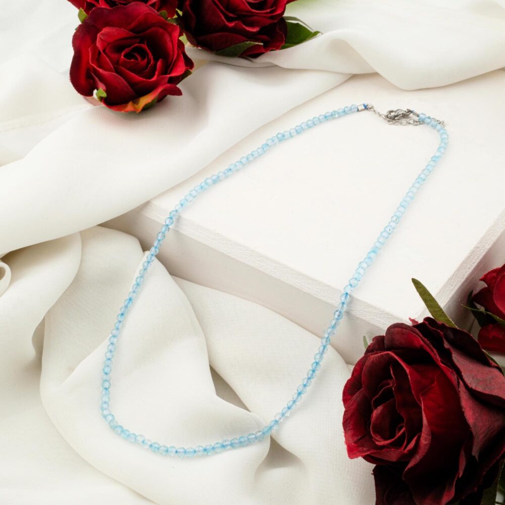Delicate 3-4mm blue topaz faceted bead necklace on white display
