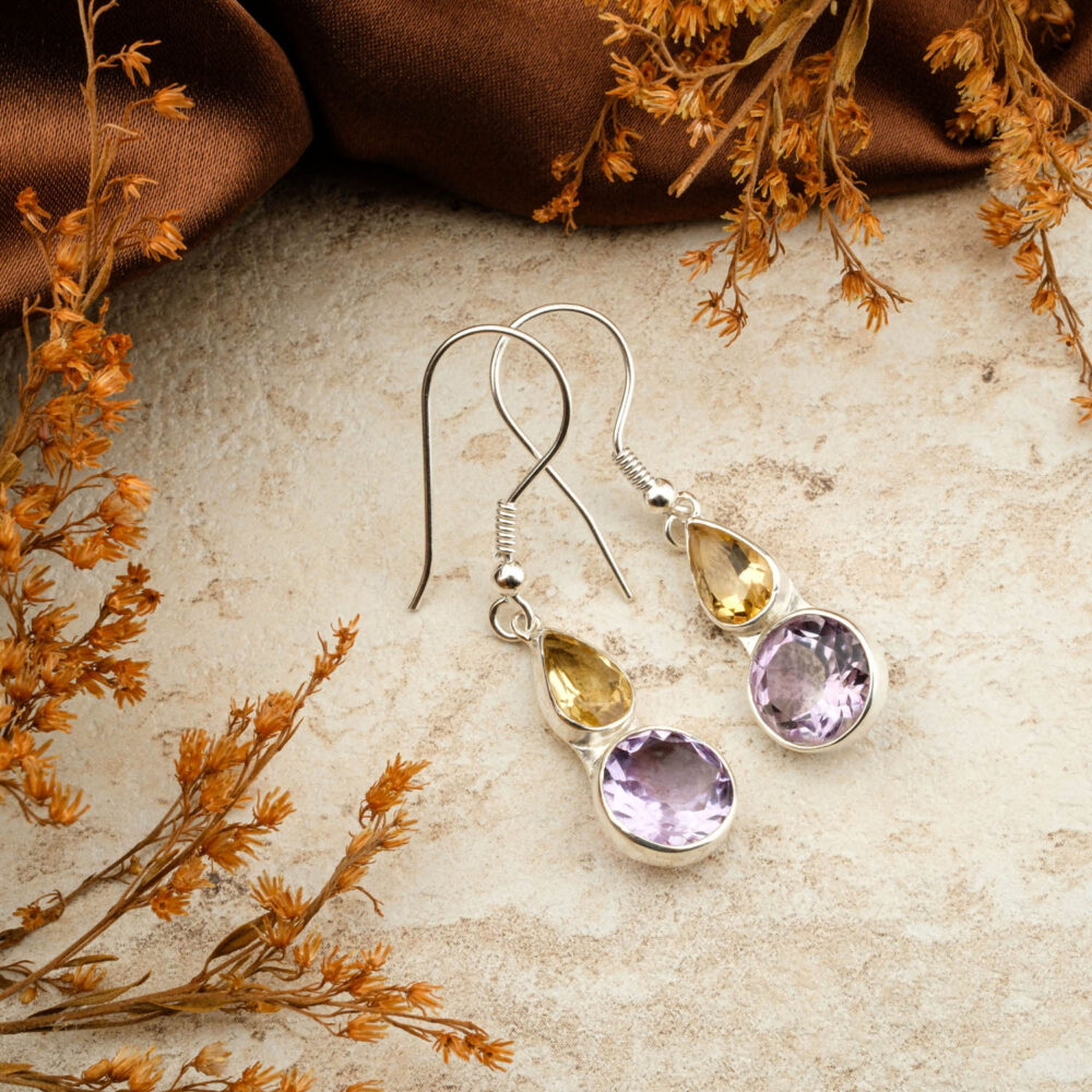 Premium Amethyst and Citrine two-stone earrings in 925 sterling silver, on a brown satin background.