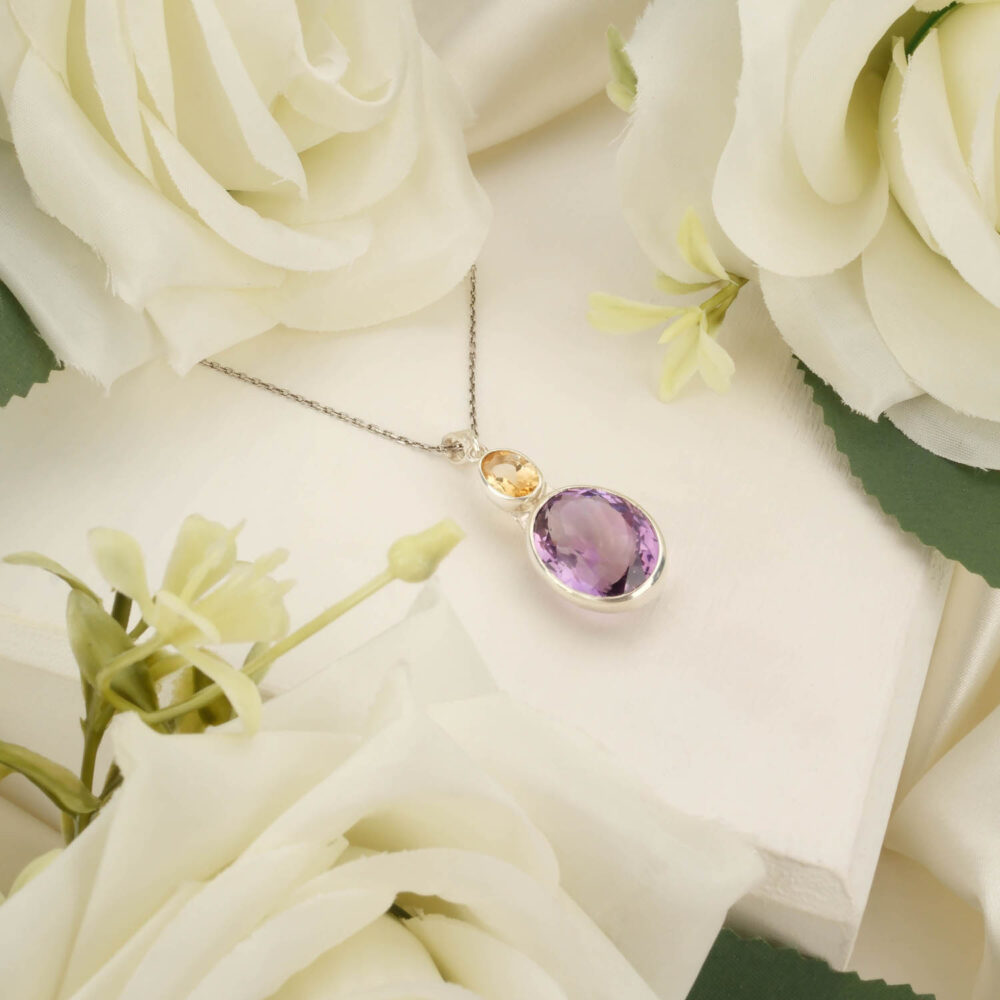 Teardrop amethyst and pear-cut citrine pendant necklace in 925 sterling silver on white background