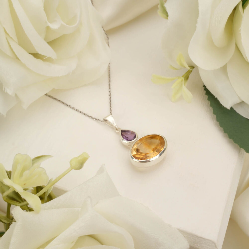 Teardrop amethyst and pear-cut citrine pendant necklace in 925 sterling silver on white background