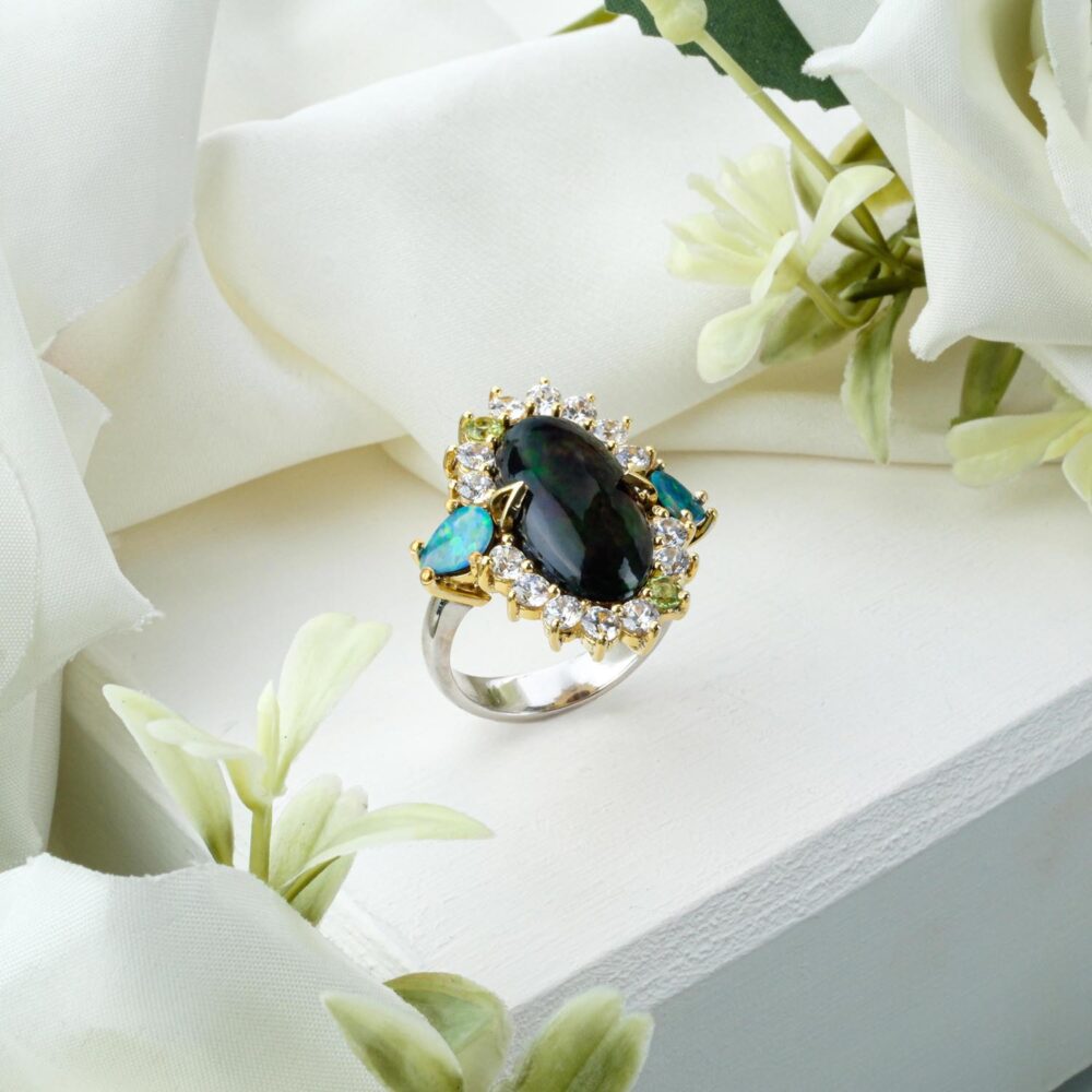 Ornate 925 sterling silver ring featuring Black Opal, Boulder Opal, and Peridot gemstones on white