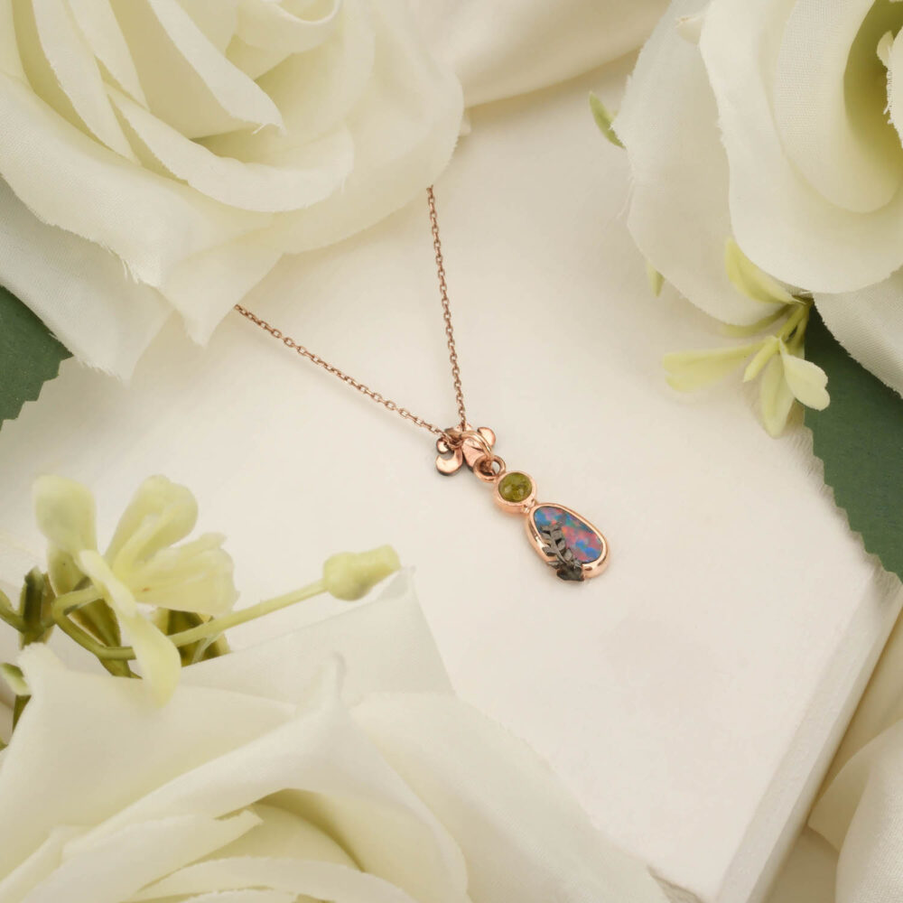 Genuine Australian Boulder Opal pendant with Peridot accents in rose gold-plated 925 sterling silver on white