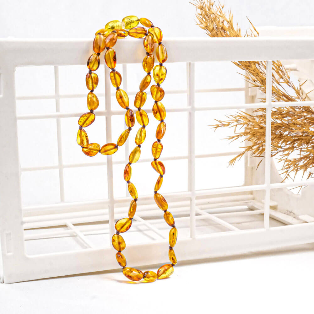 Certified genuine adult amber necklace with multi-color Baltic beads on white background