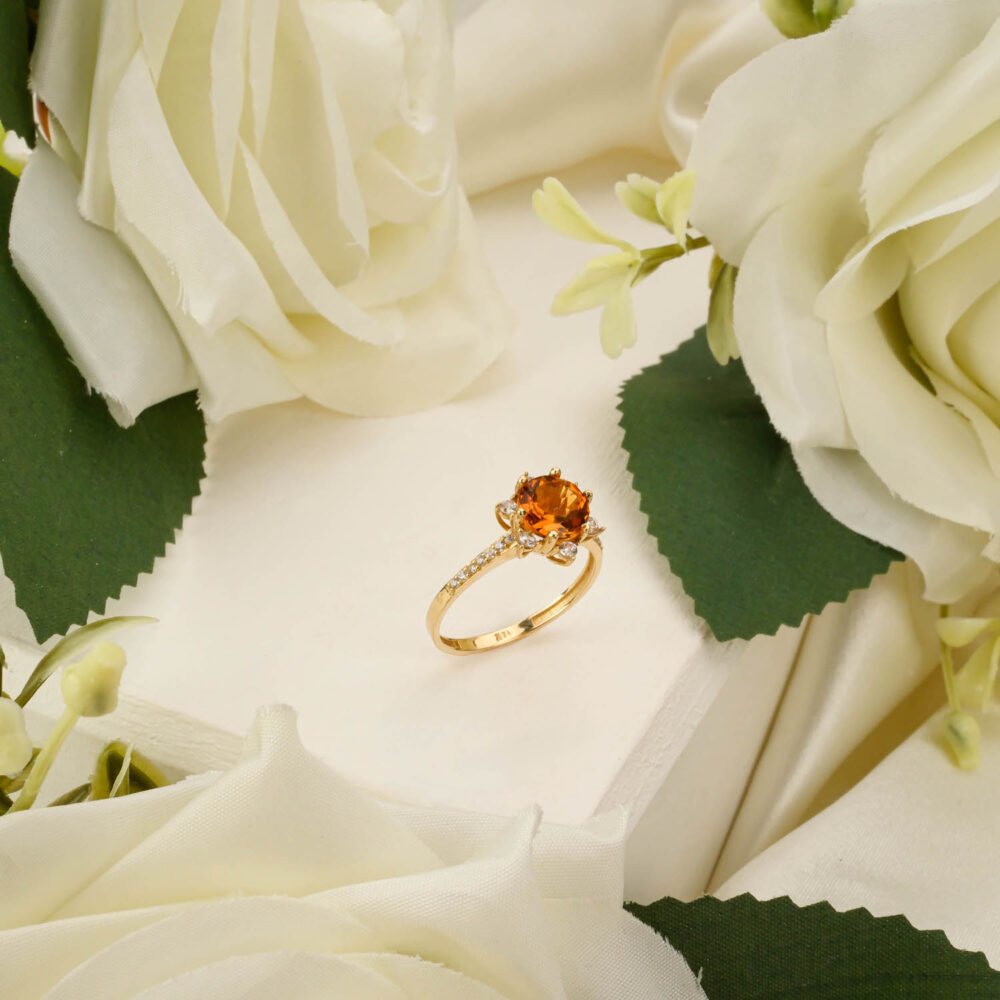 Round citrine solitaire ring with lotus flower setting in 14k yellow gold on white