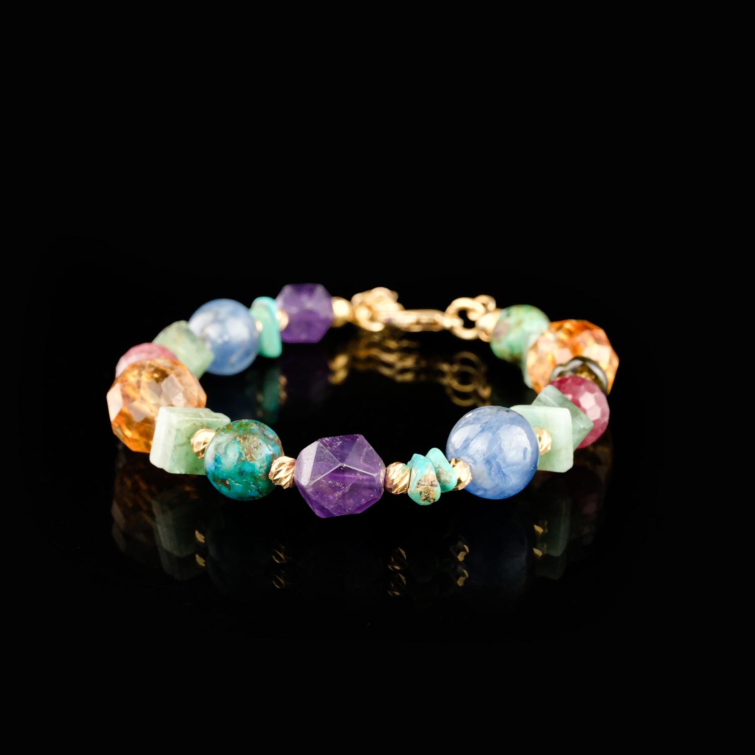 edelstahl-armband-mit-edelsteinen-smaragd-citrin-rubin Armband aus Edelstahl mit Edelsteinperlen aus Smaragd, Citrin, Peridot, Rubin, Saphir, Amethyst und Chrysokoll auf weißer Fläche mit Blumen