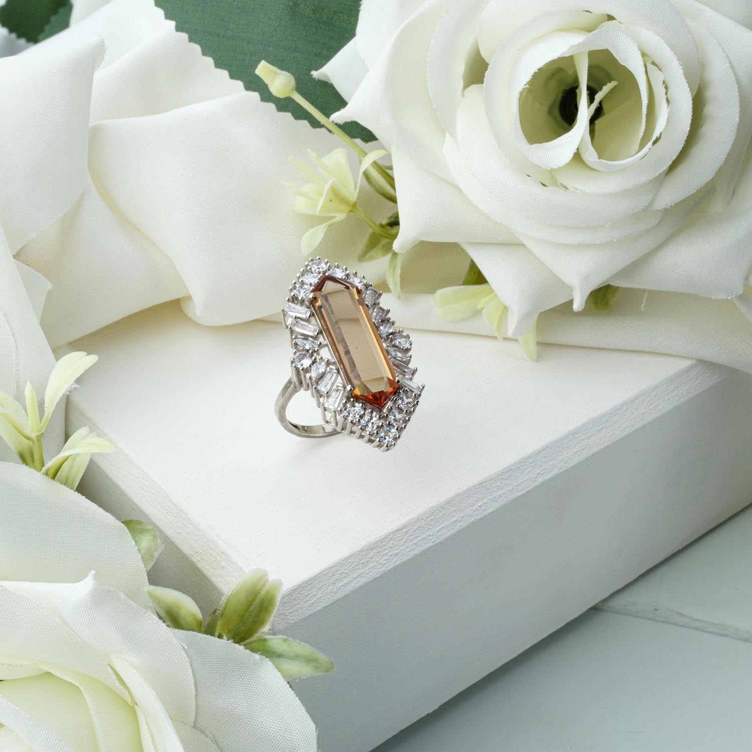 elongated-zultanite-ring-silver-sunburst Elongated hexagonal Zultanite ring in 925 sterling silver with a baguette zircon sunburst halo on white