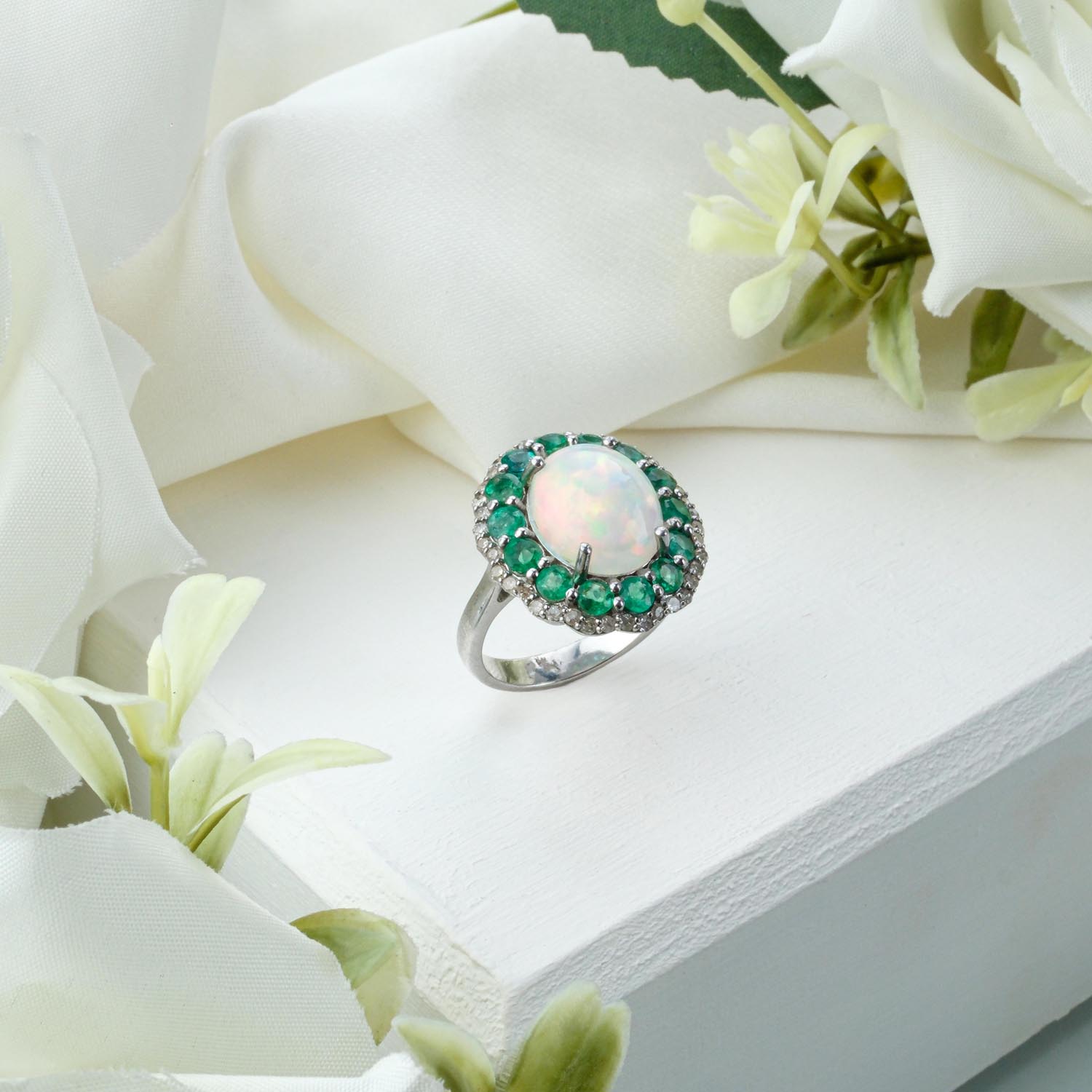 emerald-opal-diamond-silver-ring-zambian Ornate 925 sterling silver ring featuring a Zambian emerald, white opal cabochon, and diamond accents on white