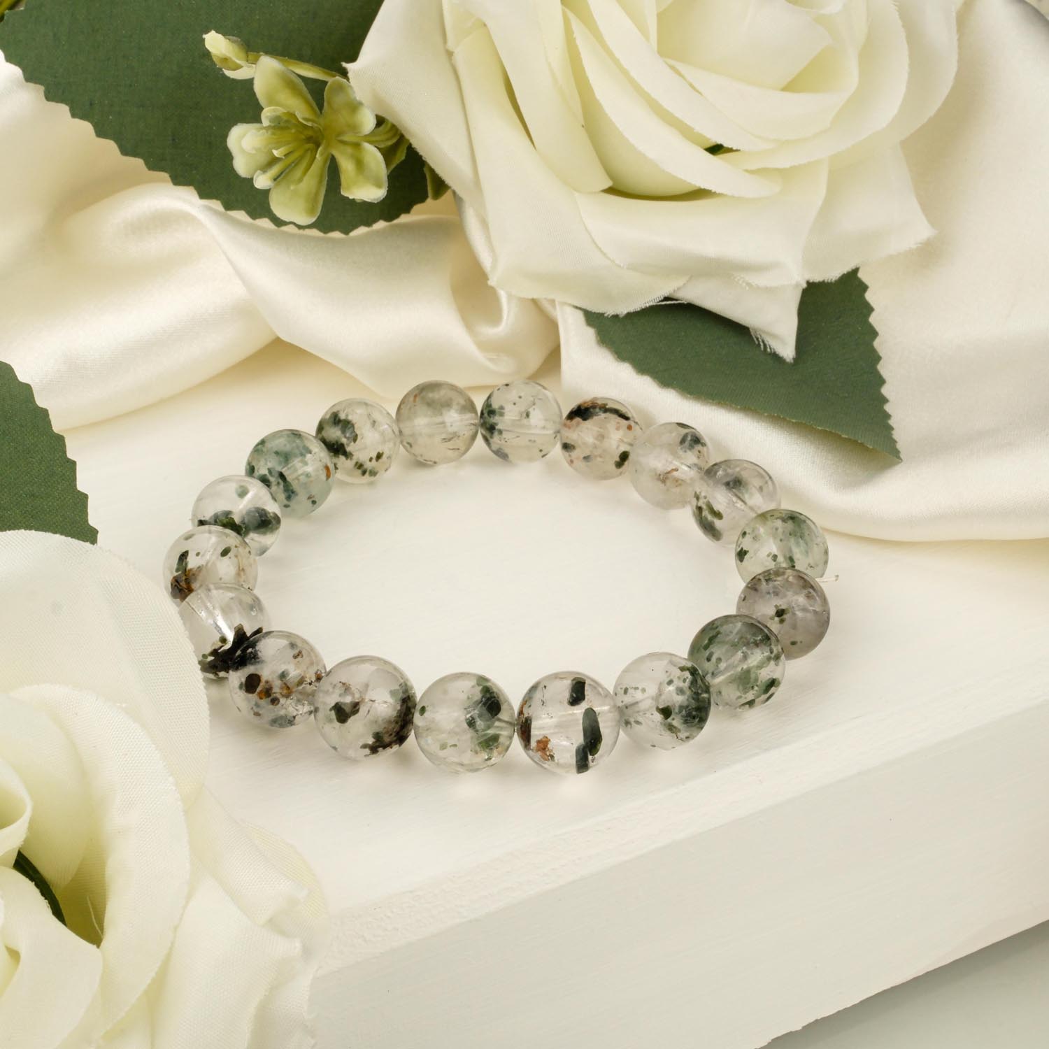 green-tourmalinated-quartz-bracelet-12mm 11-12mm green tourmalinated quartz bracelet with tourmaline inclusions on white display