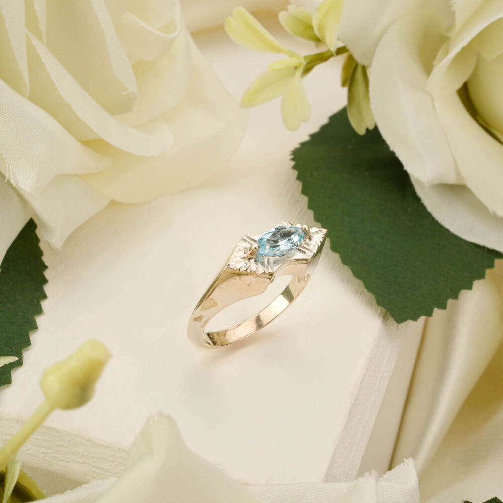 Handcrafted unisex ring featuring a deep blue topaz gemstone in 925 sterling silver on white