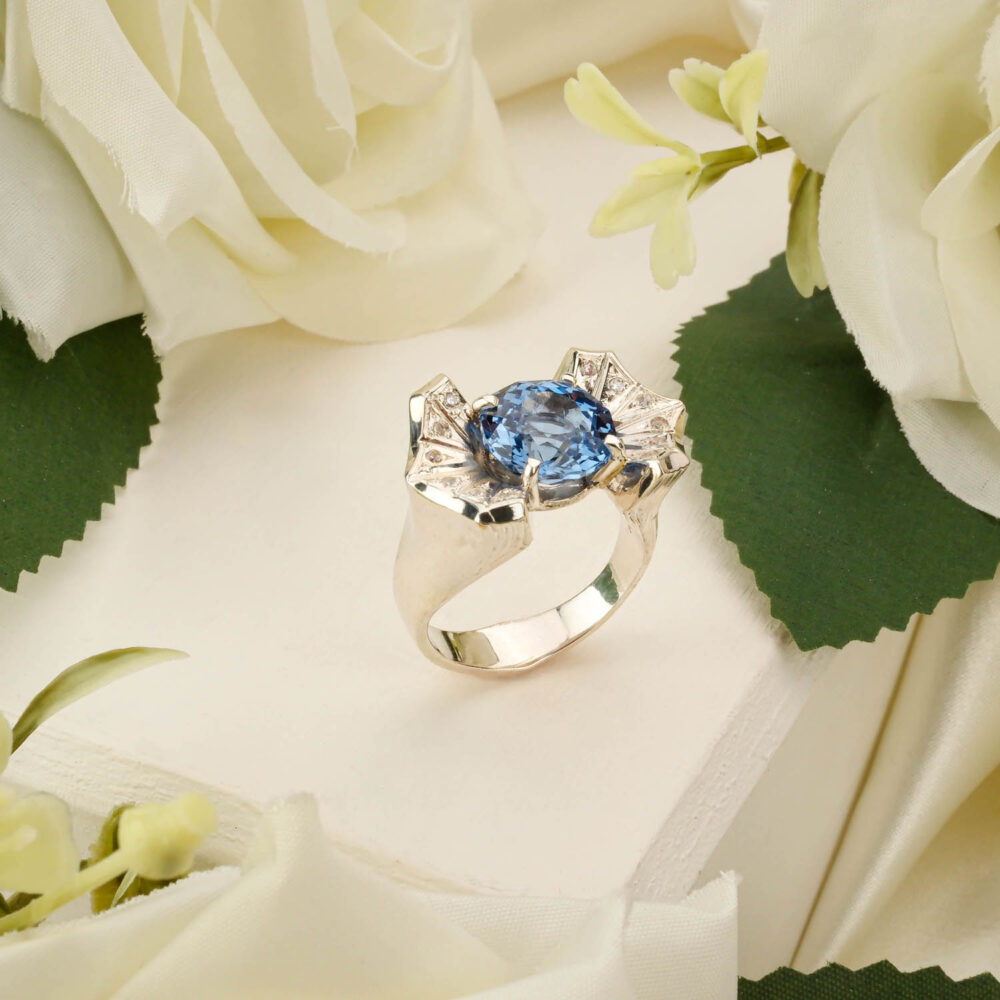 Handcrafted unisex ring featuring a deep blue topaz gemstone in 925 sterling silver on white