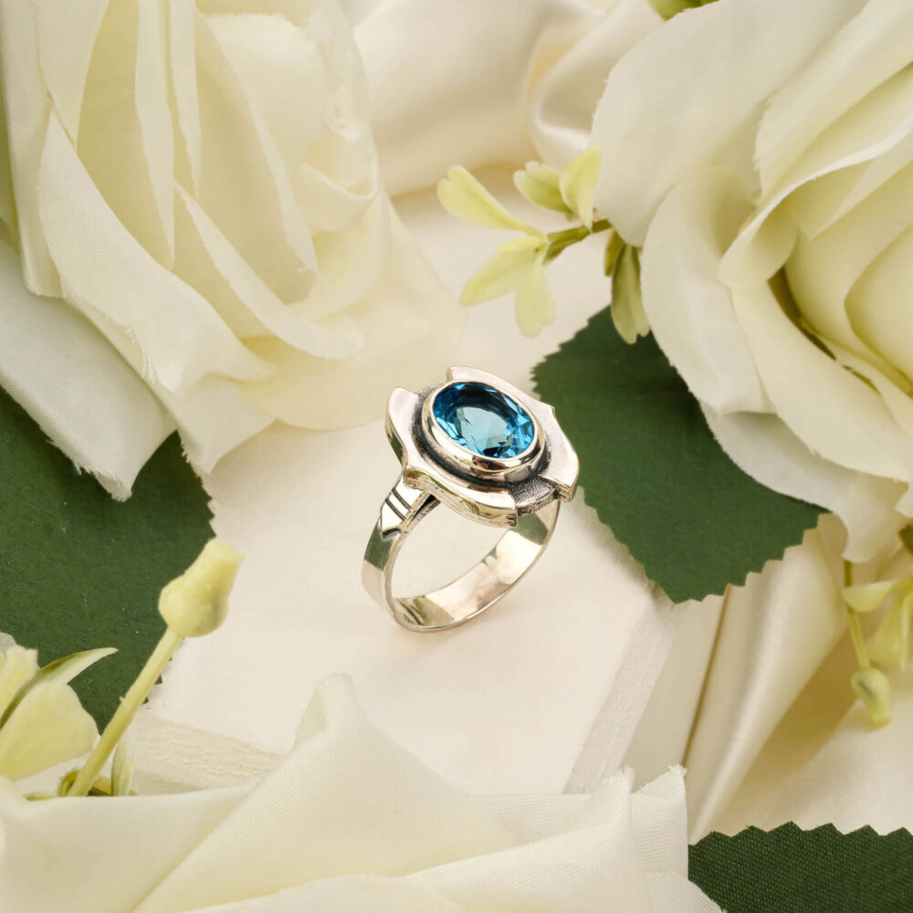 Handcrafted unisex ring featuring a sky blue topaz gemstone in 925 sterling silver on white