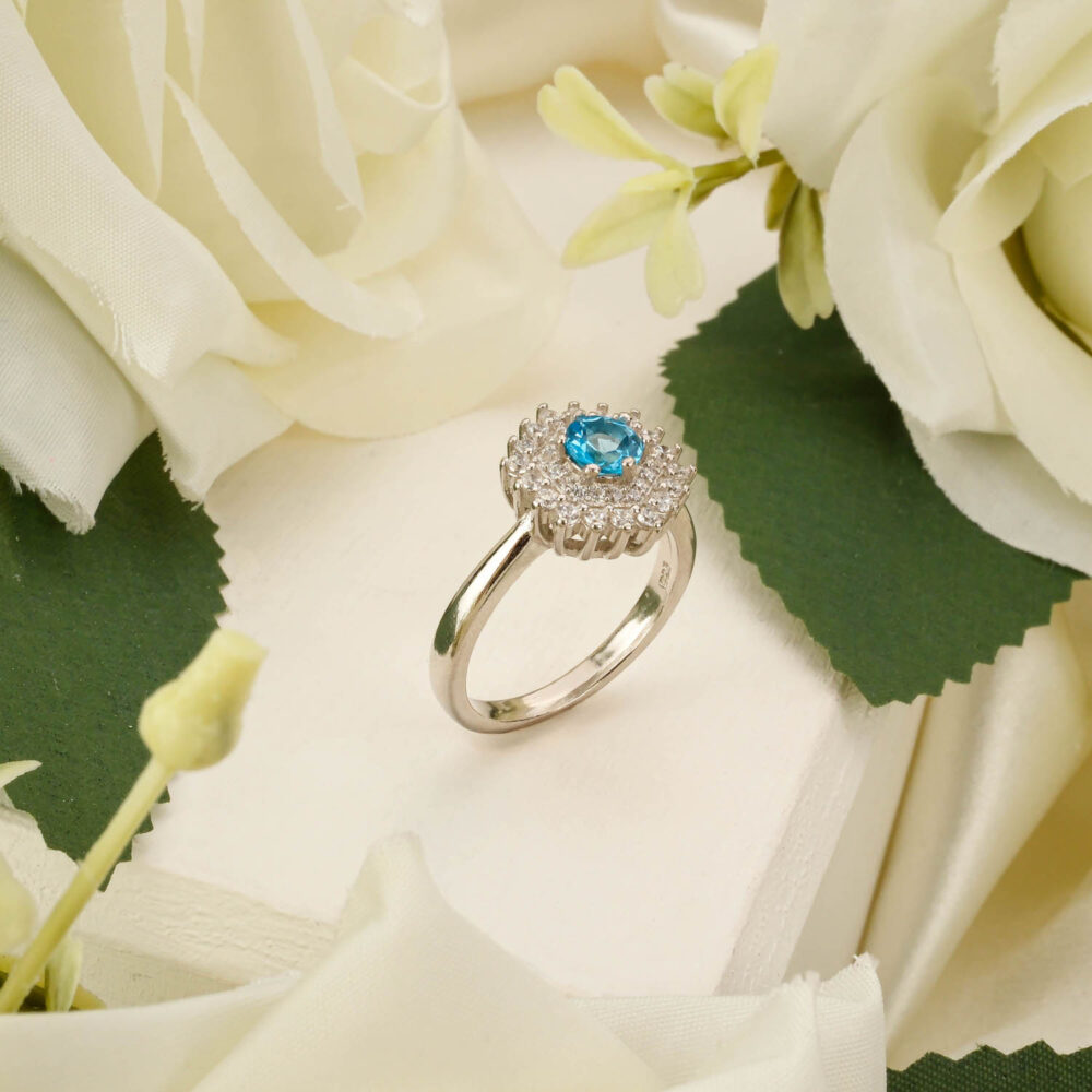 Handcrafted unisex ring featuring a sky blue topaz gemstone in 925 sterling silver on white