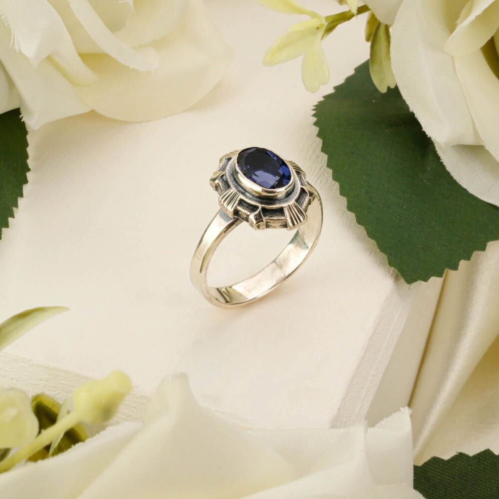 Handcrafted unisex ring featuring a genuine blue sapphire gemstone in 925 sterling silver on white
