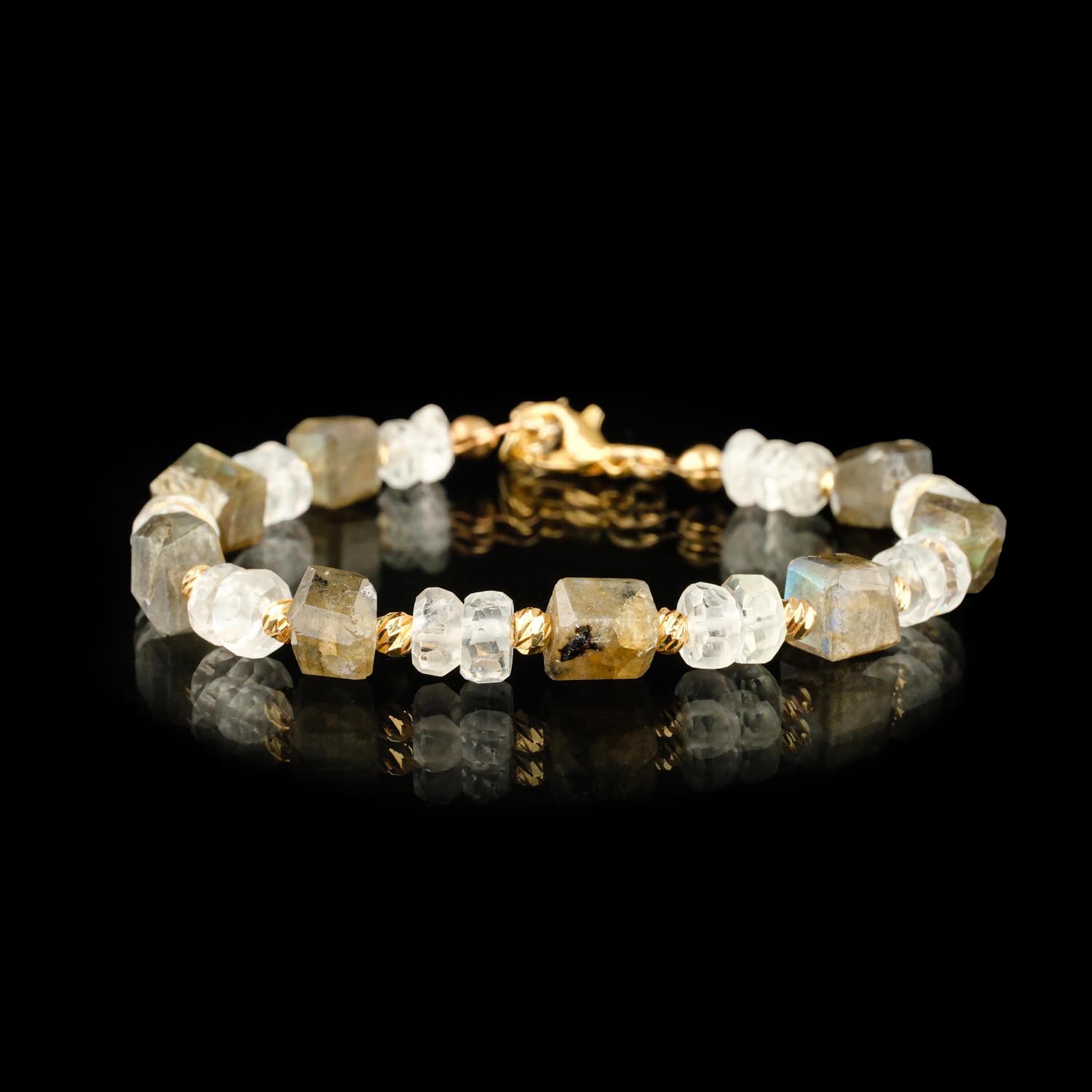 labradorit-mondstein-armband-facettiert-gold-stahl Facettiertes Labradorit- und Mondstein-Armband mit goldenen Stahlakzenten auf weiß