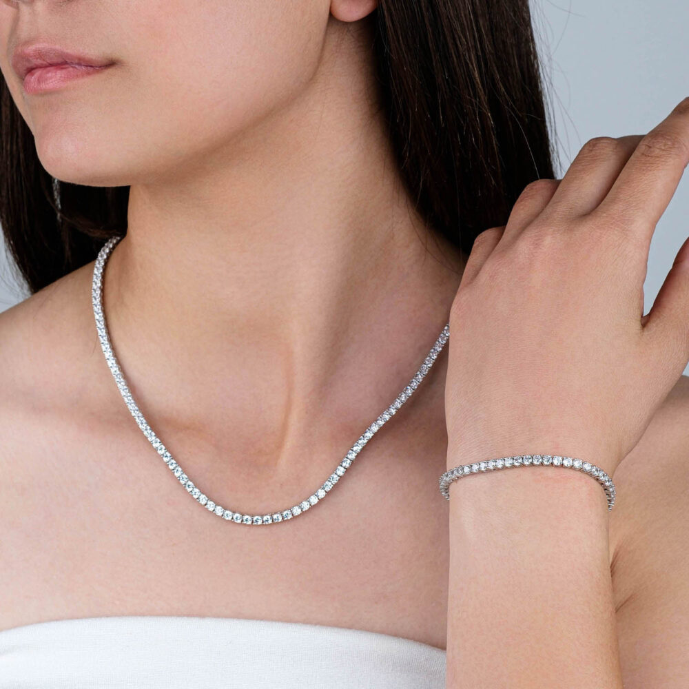 Premium Moissanite jewelry set featuring a sparkling necklace and bracelet in 925 sterling silver on black background