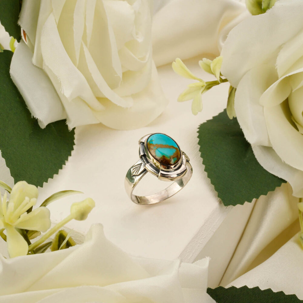 Handcrafted unisex ring featuring a genuine Nishapur turquoise stone in 925 sterling silver on white