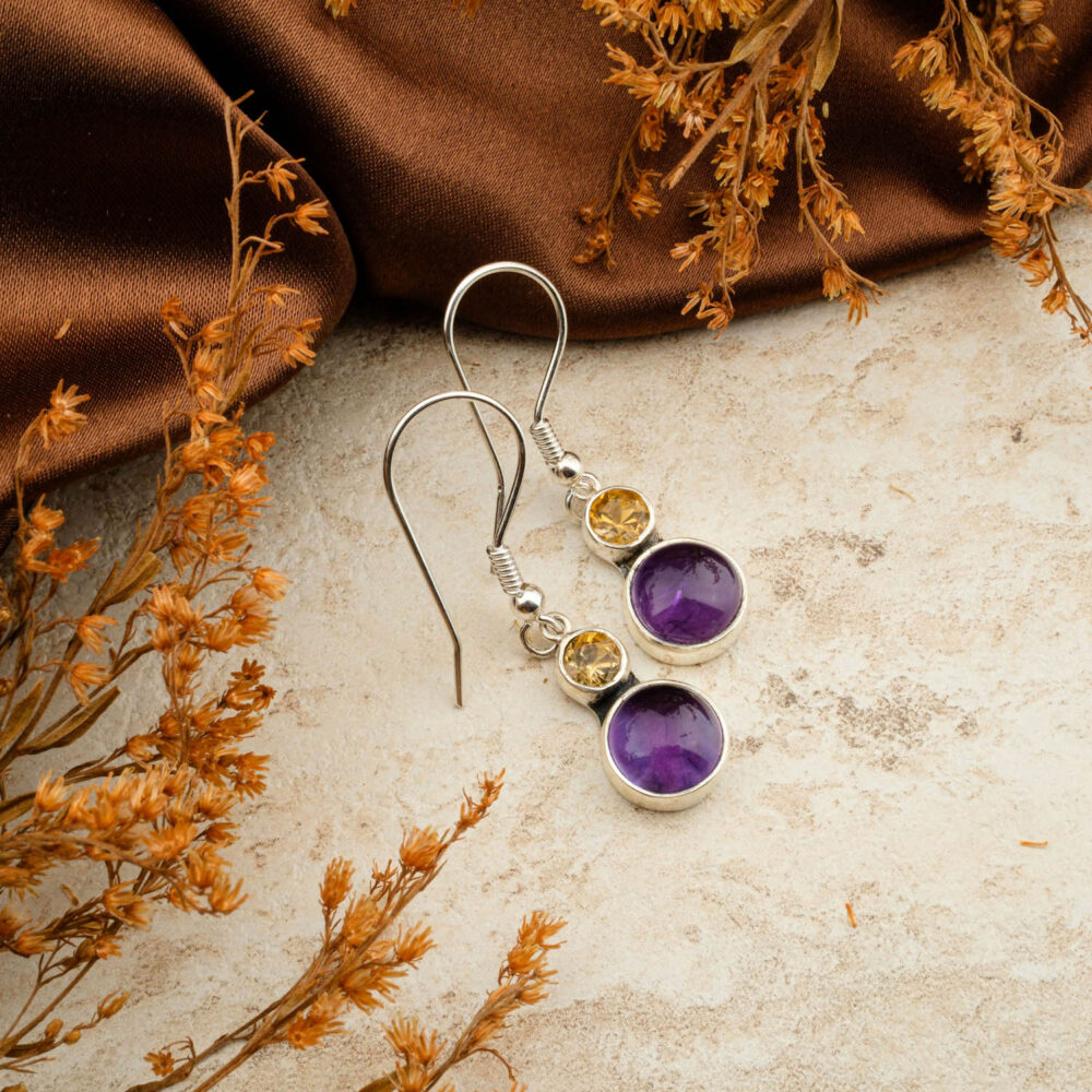 Premium Peridot (Zebercet) and Citrine two-stone earrings in 925 sterling silver, on a brown satin background.