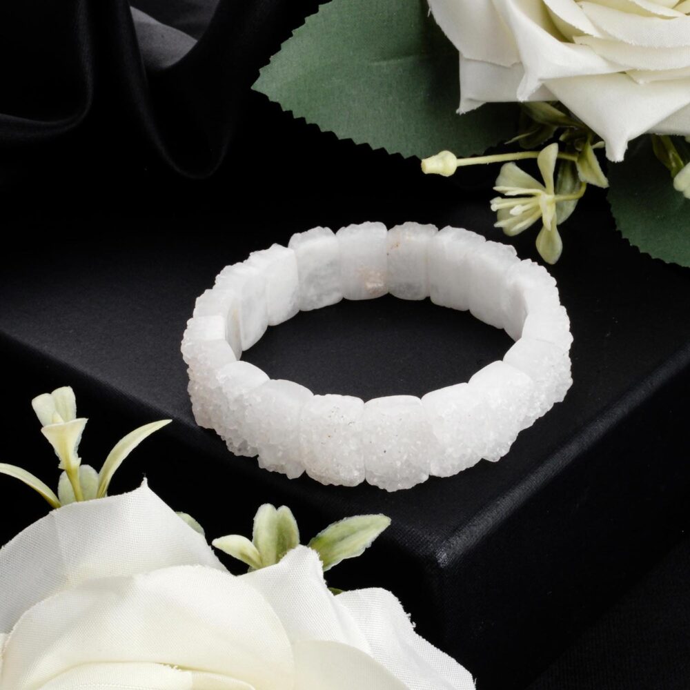 Raw crystal quartz bracelet with a white druzy texture in a 'Rolex' link style on a black box