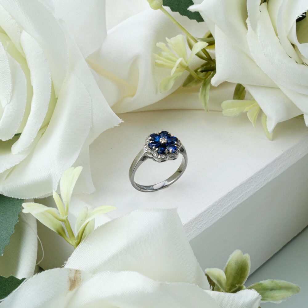 Genuine oval sapphire ring with diamond halo accents in 925 sterling silver on white