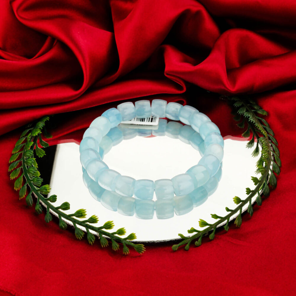 A 5A+ quality faceted Aquamarine natural stone bracelet with 10-11mm cut beads on a mirror surface.