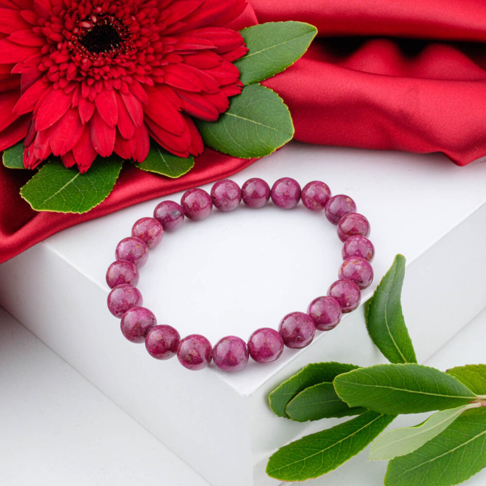 A 5A+ quality natural ruby stone beaded bracelet with 11-12mm beads, displayed on a white surface