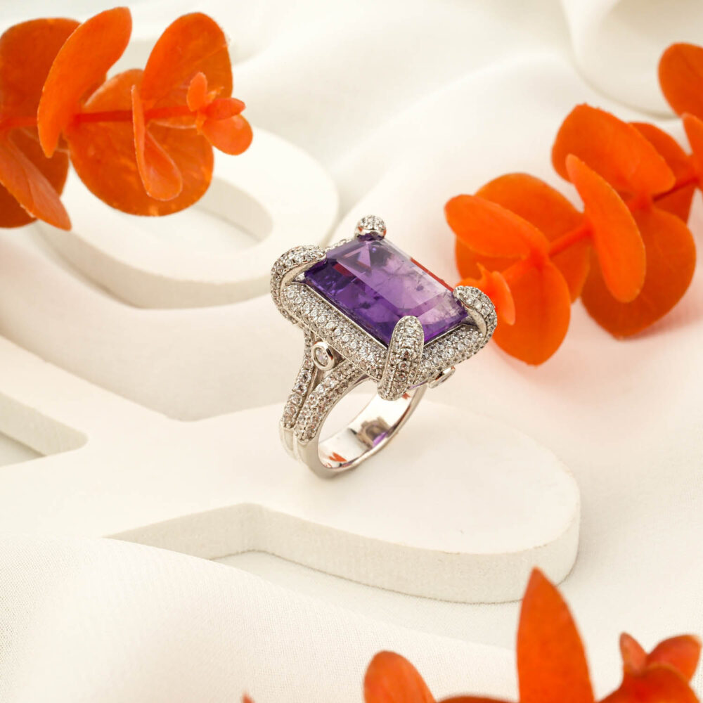 Rectangular amethyst 925 sterling silver women’s ring with pavé halo on white display